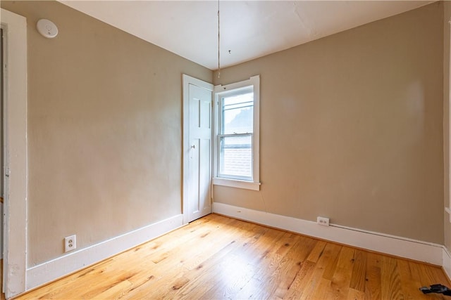 unfurnished room with light wood-type flooring