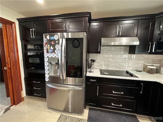 kitchen featuring tasteful backsplash, light tile patterned floors, and black appliances