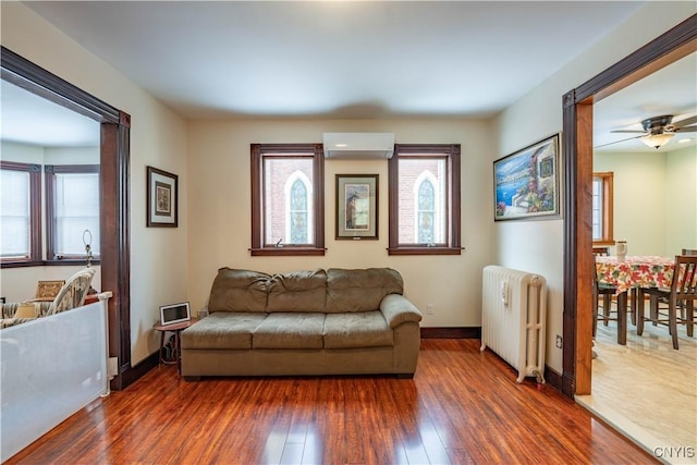 20 Petrie St, Little Falls-City, NY 13365 - living room with radiator, a wall mounted AC, and dark hardwood / wood-style floors