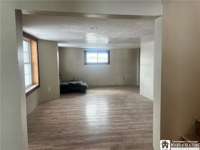 empty room featuring hardwood / wood-style flooring and a textured ceiling