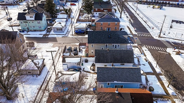 snowy aerial view with a residential view