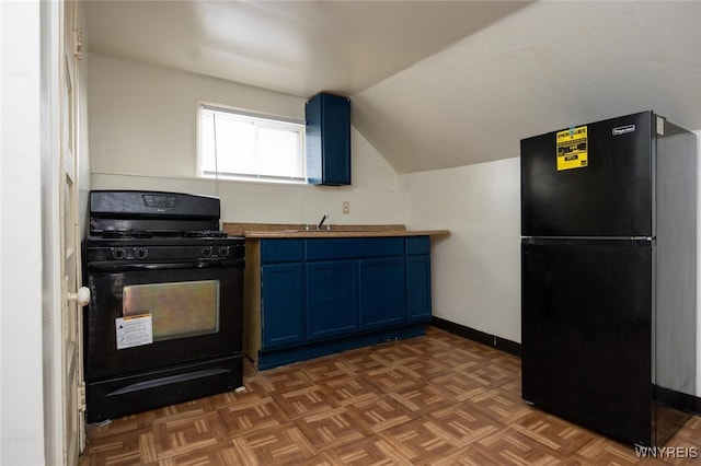 kitchen featuring black appliances, vaulted ceiling, baseboards, and blue cabinetry