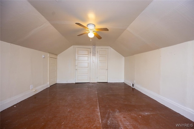 additional living space with lofted ceiling, baseboards, and a ceiling fan