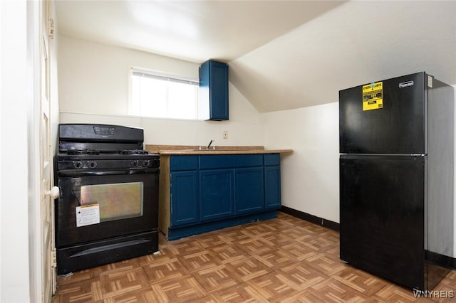 kitchen with vaulted ceiling, black appliances, baseboards, and blue cabinets