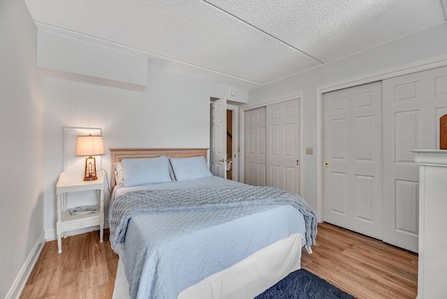 7 Cliffside Dr, South Bristol, NY 14424 - bedroom with multiple closets, wood-type flooring, and a textured ceiling