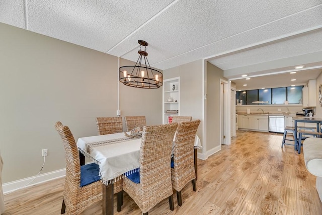 7 Cliffside Dr, South Bristol, NY 14424 - dining space with sink, an inviting chandelier, a textured ceiling, and light hardwood / wood-style floors