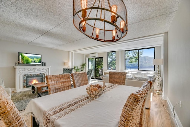 7 Cliffside Dr, South Bristol, NY 14424 - dining room with hardwood / wood-style floors, a textured ceiling, an AC wall unit, and a chandelier
