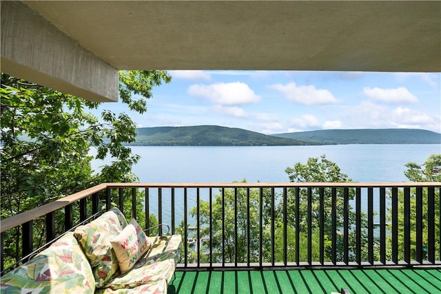 balcony with a water and mountain view