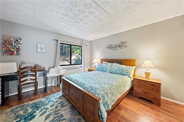 bedroom featuring dark hardwood / wood-style floors and a textured ceiling