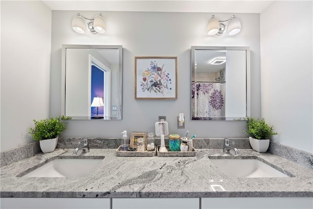 bathroom with walk in shower and vanity