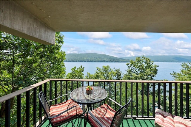 balcony with a water and mountain view