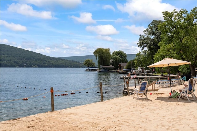 view of water feature with a mountain view and a dock