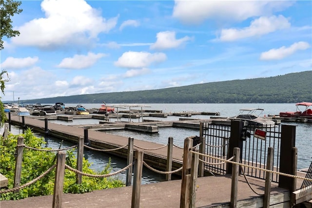 view of dock with a water and mountain view