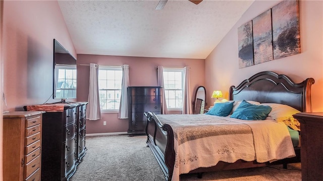 carpeted bedroom featuring lofted ceiling, ceiling fan, and a textured ceiling