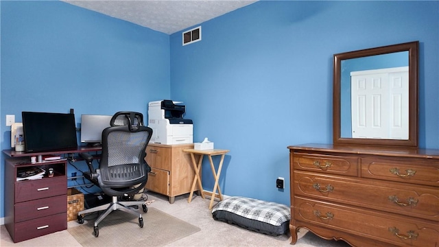 office area with light carpet and a textured ceiling