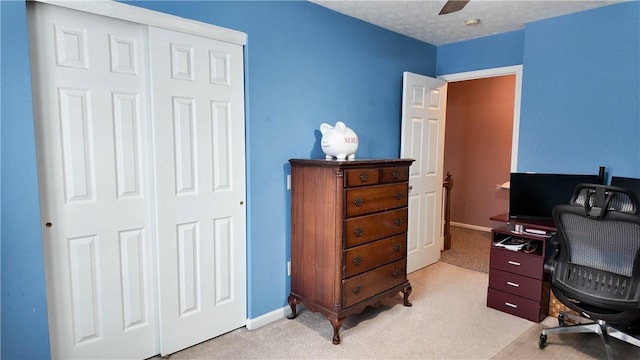 office area featuring ceiling fan, light colored carpet, and a textured ceiling