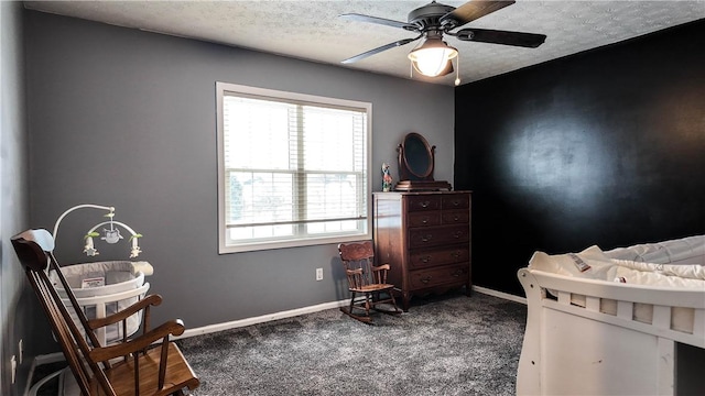 bedroom featuring ceiling fan, carpet, and a textured ceiling