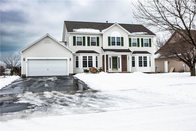 colonial inspired home featuring a garage