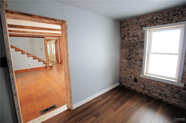 unfurnished room with dark hardwood / wood-style flooring