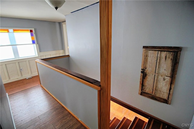 hallway with hardwood / wood-style floors