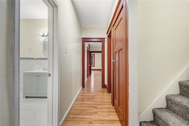 hallway with light hardwood / wood-style floors