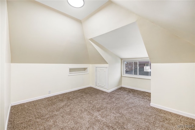 bonus room featuring carpet floors and vaulted ceiling