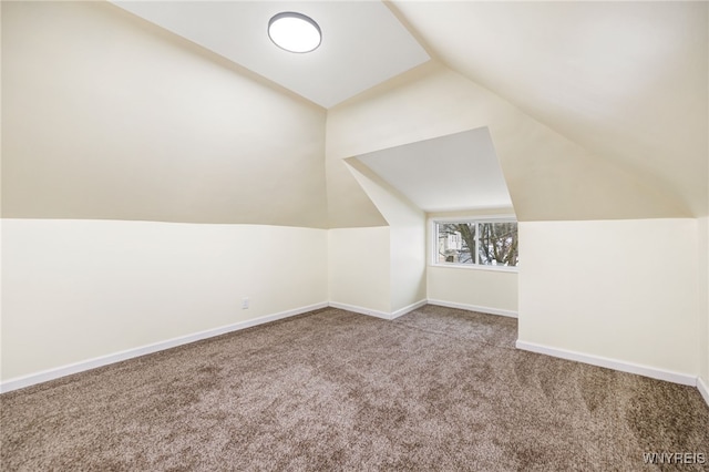 bonus room featuring vaulted ceiling and carpet flooring