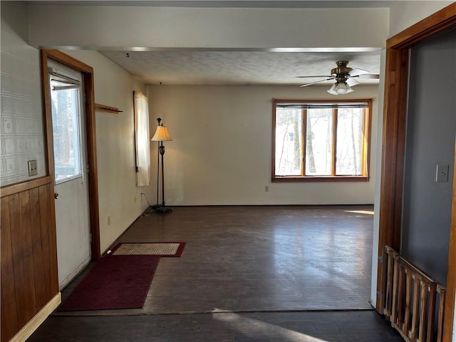 spare room with dark hardwood / wood-style flooring and ceiling fan