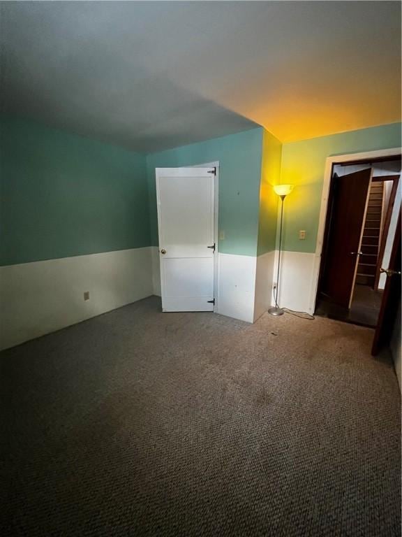 additional living space featuring carpet flooring and stairs