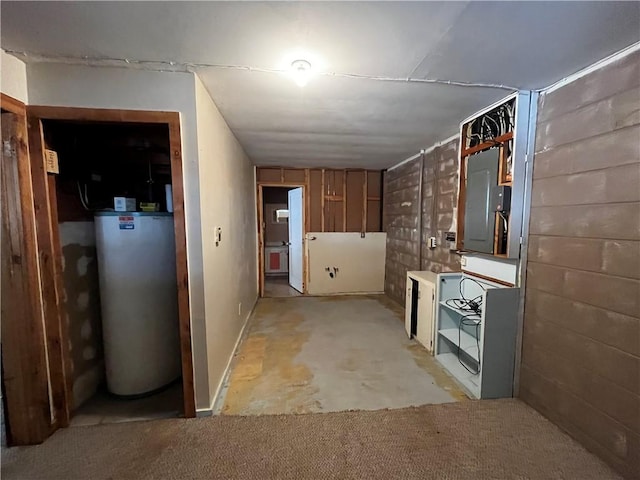 interior space featuring water heater, concrete floors, and electric panel
