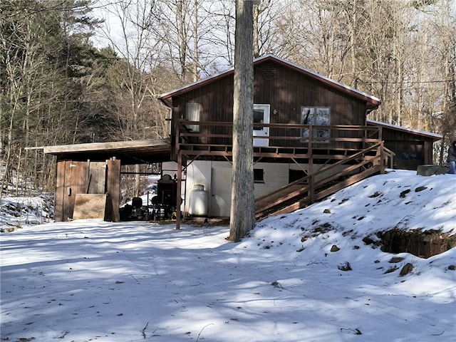 view of snowy exterior with a deck