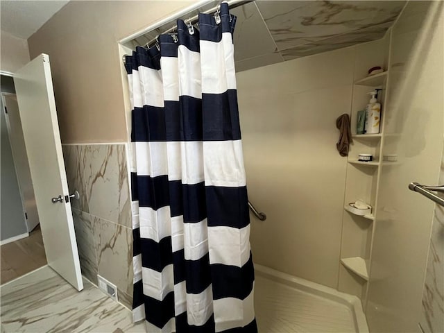 bathroom featuring tile walls and a shower with curtain