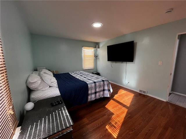 bedroom with dark wood-type flooring