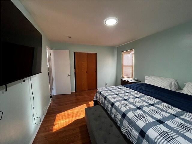 bedroom with hardwood / wood-style flooring and a closet