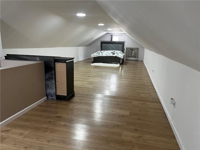 unfurnished bedroom with lofted ceiling and dark hardwood / wood-style flooring