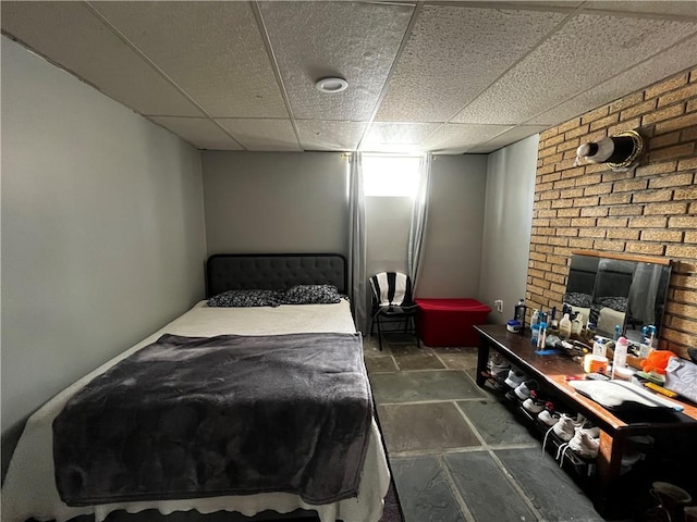 bedroom with a fireplace and a paneled ceiling