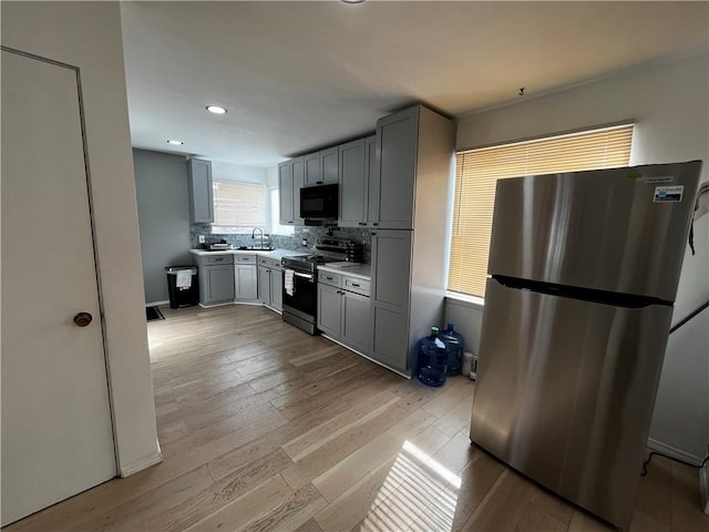 49 Lewis St, Maine, NY 13760 - kitchen with appliances with stainless steel finishes, gray cabinetry, light wood-style floors, light countertops, and recessed lighting