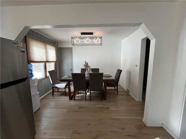 49 Lewis St, Maine, NY 13760 - dining room with light wood-type flooring, baseboards, and arched walkways