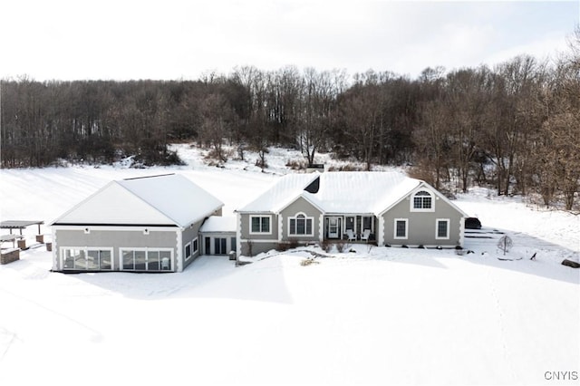 view of snow covered back of property