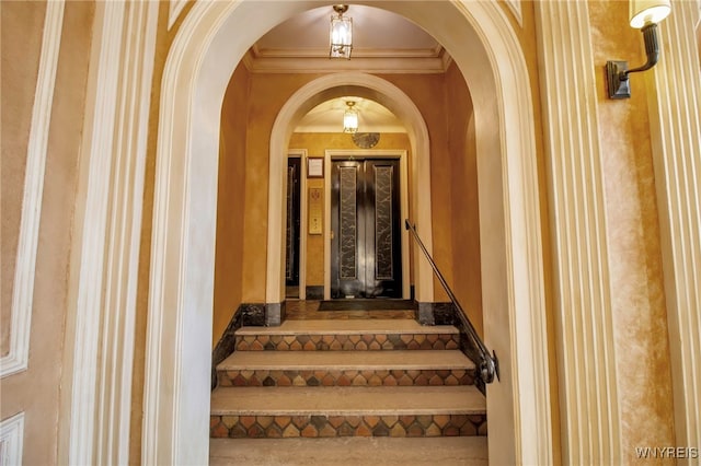 staircase featuring crown molding