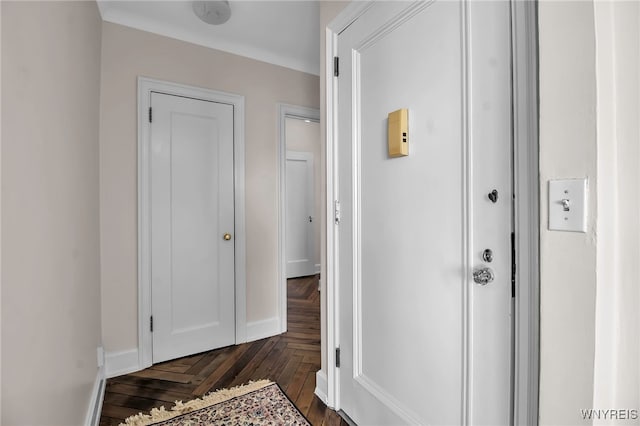 hallway featuring dark parquet flooring