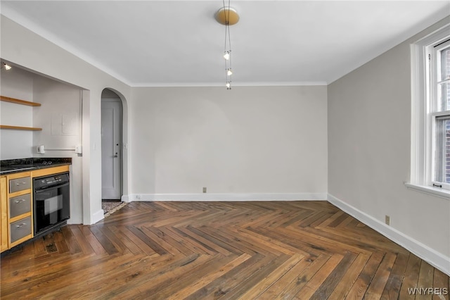 kitchen featuring crown molding, dark parquet flooring, and oven