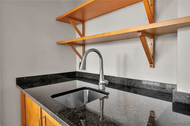 interior details with sink and dark stone countertops