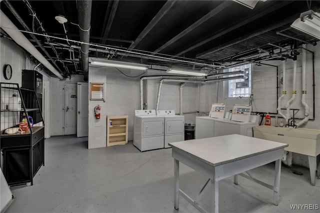 basement with separate washer and dryer and sink