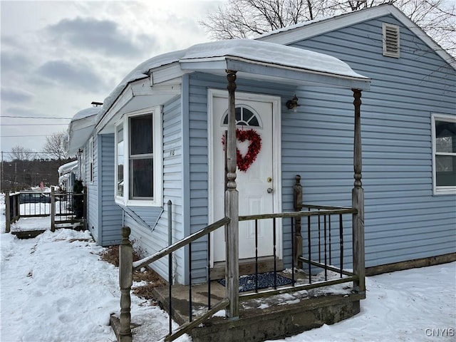 view of snow covered property entrance