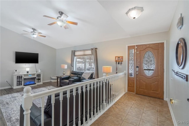 tiled entryway featuring lofted ceiling