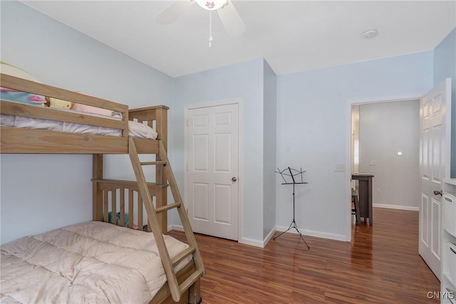 bedroom with dark hardwood / wood-style flooring and ceiling fan