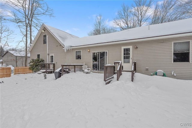 view of snow covered rear of property