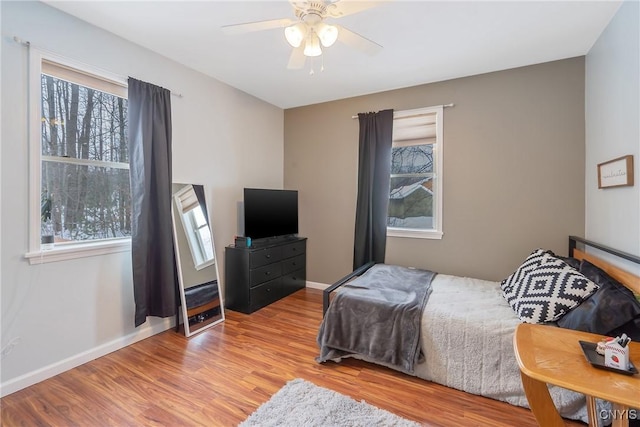 bedroom with light hardwood / wood-style floors and ceiling fan