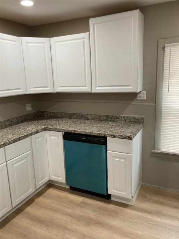 kitchen with baseboards, white cabinets, light wood finished floors, and dishwashing machine